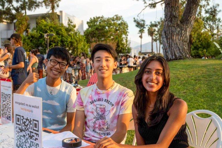 Students sit ready to answer questions at the club fair